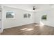 Bright bedroom with natural light from three windows and sleek wood-look floors at 3401 E Hanna Ave, Tampa, FL 33610