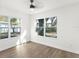 Sun-filled bedroom featuring wood floors and multiple windows offering an airy atmosphere at 3401 E Hanna Ave, Tampa, FL 33610