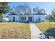 Charming single-story home with fresh white paint, a walkway, and a manicured front yard at 3401 E Hanna Ave, Tampa, FL 33610