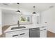 Modern kitchen featuring stainless steel appliances, white countertops, and a breakfast bar at 3401 E Hanna Ave, Tampa, FL 33610