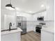 Bright kitchen featuring white cabinets, stainless steel appliances, and an island at 3401 E Hanna Ave, Tampa, FL 33610