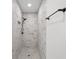 Elegant walk-in shower with marble-look tiling, niche, and rainfall shower head at 3401 E Hanna Ave, Tampa, FL 33610