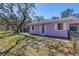 Angle view of a single-story home with a fenced yard and a well-maintained lawn at 5010 109Th N Way, St Petersburg, FL 33708