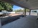 Spacious backyard features new soil, a white fence, mature shade trees, and a covered patio at 509 N Bradford Ave, Tampa, FL 33609