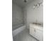 Modern bathroom featuring white cabinets, marble flooring, and a shower-over-tub with glass door at 509 N Bradford Ave, Tampa, FL 33609