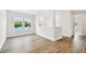 Upstairs bonus room with hardwood floors, natural light, and access to other rooms at 509 N Bradford Ave, Tampa, FL 33609
