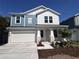 Charming two-story home with a two-car garage, lovely landscaping and a blue accent at 509 N Bradford Ave, Tampa, FL 33609