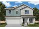 Charming two-story home with a two-car garage, landscaped yard, and covered entryway at 509 N Bradford Ave, Tampa, FL 33609