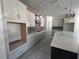 Well-lit kitchen featuring white cabinets, gray backsplash, stainless steel vent hood, and pendant lights at 509 N Bradford Ave, Tampa, FL 33609