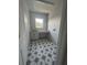 Bright laundry room features a white countertop, cabinet storage, window, and decorative star pattern tile flooring at 509 N Bradford Ave, Tampa, FL 33609