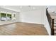 Open-concept living area featuring hardwood floors, recessed lighting, and staircase at 509 N Bradford Ave, Tampa, FL 33609