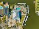 Aerial view of an expansive waterfront estate featuring a pool, private docks, and meticulous landscaping at 6029 Bayway Ct, New Port Richey, FL 34652