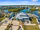 Impressive aerial view of a waterfront home showcasing lush landscaping, and multiple docks on the intercostal at 6029 Bayway Ct, New Port Richey, FL 34652