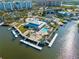 Aerial view of waterfront home with a pool, boat docks, and lush landscaping near the intercostal at 6029 Bayway Ct, New Port Richey, FL 34652