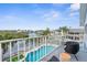 Balcony overlooking a community pool and canal views, complete with outdoor seating at 6029 Bayway Ct, New Port Richey, FL 34652