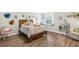 Bright bedroom with wood-look floors, window seat, and playful decor for a cozy and inviting space at 6029 Bayway Ct, New Port Richey, FL 34652