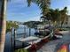 Waterfront property featuring a private dock with boat lift and beautiful landscaping at 6029 Bayway Ct, New Port Richey, FL 34652