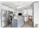 Bright kitchen with stainless steel appliances, stylish island, and open floor plan at 6029 Bayway Ct, New Port Richey, FL 34652