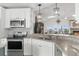 Modern kitchen with stainless steel appliances, granite countertops, and open view at 6029 Bayway Ct, New Port Richey, FL 34652