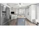 Bright and modern kitchen with stainless steel appliances, center island, and wood flooring at 6029 Bayway Ct, New Port Richey, FL 34652