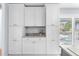 Modern kitchen with white cabinets, granite countertops, and elegant design at 6029 Bayway Ct, New Port Richey, FL 34652