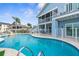 Backyard pool with inviting blue water, lush landscaping, a patio and upper deck, creating a private oasis at 6029 Bayway Ct, New Port Richey, FL 34652