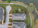 An aerial view of a well-landscaped property, neatly manicured with lush greenery and a picturesque pond at 650 Saxony Blvd, St Petersburg, FL 33716