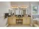 Bright bathroom featuring double vanity with granite countertop, decorative lighting and a window for natural light at 650 Saxony Blvd, St Petersburg, FL 33716