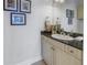 Elegant bathroom featuring a granite countertop and decorative artwork at 650 Saxony Blvd, St Petersburg, FL 33716