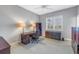 Bedroom contains a ceiling fan, plantation shutters on the window, and dark wood furnishings at 650 Saxony Blvd, St Petersburg, FL 33716