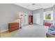 Spacious bedroom with neutral walls, carpet floors, a ceiling fan, and a large window with plantation shutters at 650 Saxony Blvd, St Petersburg, FL 33716