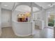 Elegant dining area with pillars, chandelier, and natural light from the front door at 650 Saxony Blvd, St Petersburg, FL 33716
