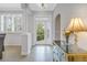 Bright foyer featuring tiled floors, a decorative table, and a partial view of dining area at 650 Saxony Blvd, St Petersburg, FL 33716