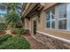 Inviting home entrance with stone accents, a brick pathway, and lush landscaping at 650 Saxony Blvd, St Petersburg, FL 33716