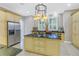 Spacious kitchen with granite island, stainless steel refrigerator, and view of the beautiful backyard through bright windows at 650 Saxony Blvd, St Petersburg, FL 33716