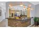 Open concept kitchen with granite counters, tiled bar, pendant lighting, and modern stainless steel appliances at 650 Saxony Blvd, St Petersburg, FL 33716