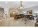 Open living room with tile floors, comfortable seating, and easy access to the kitchen and staircase at 650 Saxony Blvd, St Petersburg, FL 33716