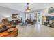 Comfortable living room with tile floors, large windows, fireplace and elegant light fixture at 650 Saxony Blvd, St Petersburg, FL 33716