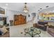 Open-concept living room with staircase, fireplace, tile floors, and stylish furnishings at 650 Saxony Blvd, St Petersburg, FL 33716
