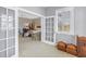 Spacious bedroom boasts neutral walls, plush carpeting, and natural light through shuttered windows and doorway at 650 Saxony Blvd, St Petersburg, FL 33716
