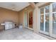 Covered outdoor patio equipped with a built-in grill, ceiling fan, and access to indoor and outdoor spaces at 650 Saxony Blvd, St Petersburg, FL 33716
