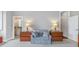 Sitting area with love seat, throw pillows, matching lamps, and wood cabinetry at 650 Saxony Blvd, St Petersburg, FL 33716
