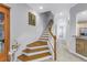 Bright staircase with wood steps, white risers, and decorative molding at 650 Saxony Blvd, St Petersburg, FL 33716