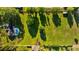 Aerial shot showcasing a home, pool, large grassy yard, and fenced perimeter, creating a private outdoor space at 7213 Jones Rd, Odessa, FL 33556