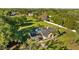 Overhead view of the home with a private pool, surrounded by a well-maintained lawn and mature landscaping at 7213 Jones Rd, Odessa, FL 33556