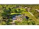 Aerial view of home showcasing a pool, lush green lawn, surrounded by trees, offering a private retreat at 7213 Jones Rd, Odessa, FL 33556