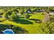 Aerial perspective capturing the home and its large, well-maintained lawn and wooden fence, enhancing its appeal at 7213 Jones Rd, Odessa, FL 33556
