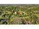 Expansive aerial view of a property nestled in a lush, wooded area, showcasing its serene and private setting at 7213 Jones Rd, Odessa, FL 33556