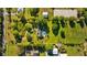 Property aerial view showing overall acreage, including home, pool, fenced yard and surrounding landscape at 7213 Jones Rd, Odessa, FL 33556