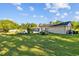 Exterior view of home from yard featuring in-ground pool, patio, and lush grassy area at 7213 Jones Rd, Odessa, FL 33556